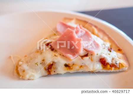 Close up of a piece of Pizza on the table 40829717