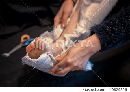 removal of gypsum bandage from broken leg 40829836