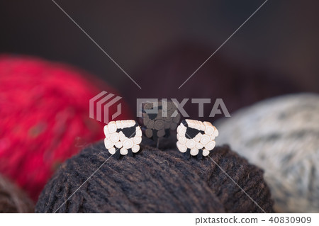 Cute white and black sheep on the yarn balls 40830909