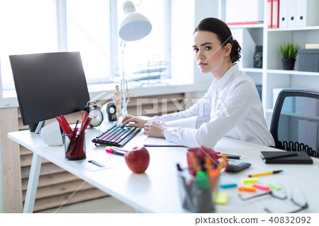 Young girl in the office working with documents at the computer. 40832092