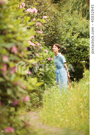 A woman walking in the garden A woman walking in the garden 40832645