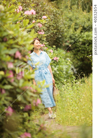 A Woman Walking In The Garden Stock Photo 40832654 Pixta