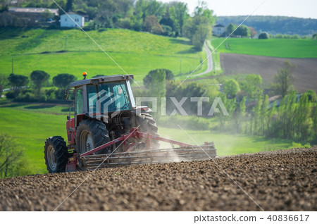 Tractor plowing field and beautiful landscape, France Tractor plowing field and beautiful landscape, France 40836617