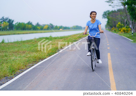 Girl with bike, Woman riding a bicycle on road Girl with bike, Woman riding a bicycle on road 40840204