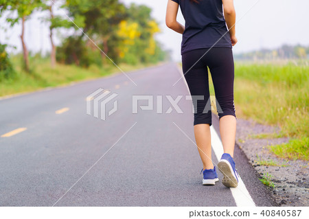 Woman feet running on road, Healthy fitness woman training 40840587