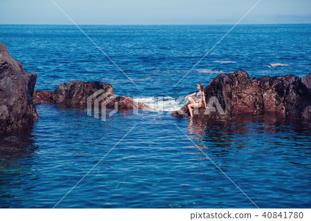 beautiful girl resting in natural ocean swimming pool 40841780