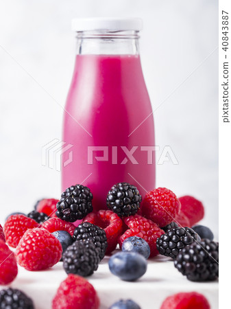 Glass bottle with fresh summer berries smoothie Glass bottle with fresh summer berries smoothie 40843887