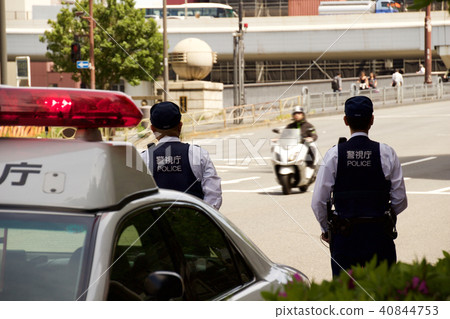 A police officer watching a traffic car 40844753