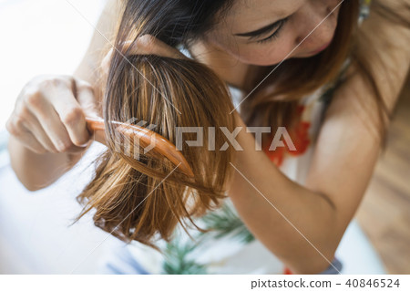 Woman combing tangled hair, Hair problems concept Woman combing tangled hair, Hair problems concept 40846524