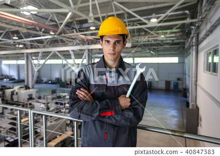 Worker with wrench at CNC factory 40847383