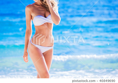 Tanned woman body in white bikini 40849690