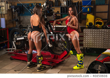 Sexy girls repairing motorcycle Sexy girls repairing motorcycle 40850608
