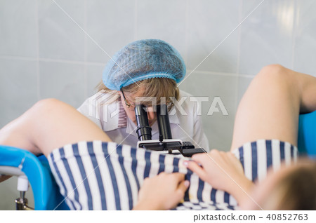 Professional gynecologist examining her female patient on a gynecological chair. 40852763