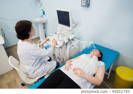 Pregnant woman doing ultrasound scan in the prenatal clinic, mother worried about health of her 40852793