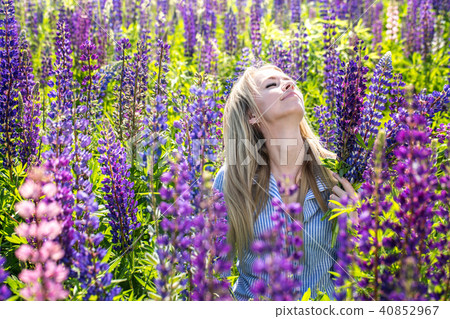 A girl is enjoys flowers 40852967