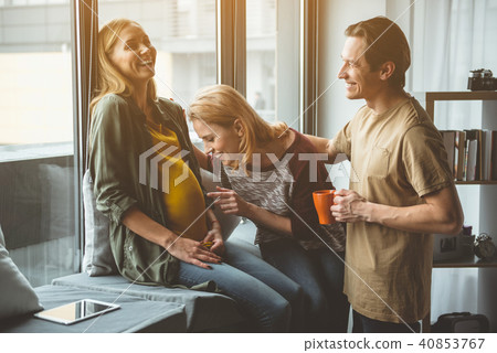 Happy future parents talking to baby inside surrogate mother belly  Happy future parents talking to baby inside surrogate mother belly  40853767