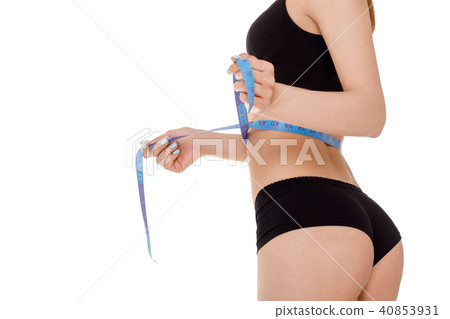 woman measuring waist with blue measuring tape. 40853931