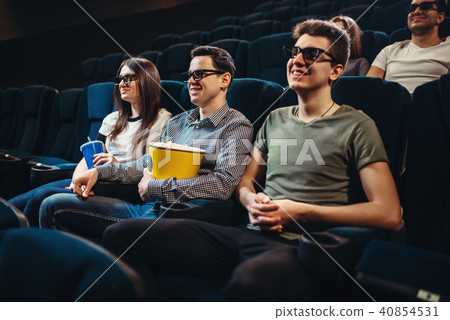 People with popcorn watching movie in cinema 40854531