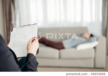 Patient lies on sofa at psychotherapist reception 40854898
