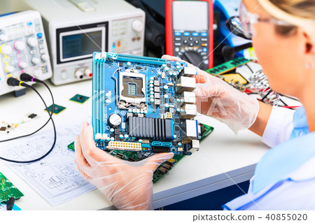 Electronic engineer examining computer motherboard 40855020