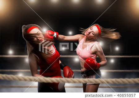 Female kickboxers in action, fighting on the ring Female kickboxers in action, fighting on the ring 40855057