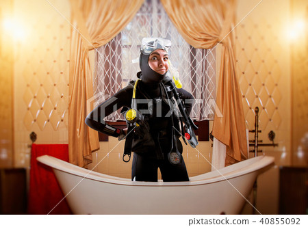 Diver in diving gear, desert island on background Diver in diving gear, desert island on background 40855092