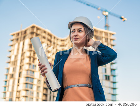beatiful business woman engineer is standing with plan papers. beatiful business woman engineer is standing with plan papers. 40856290