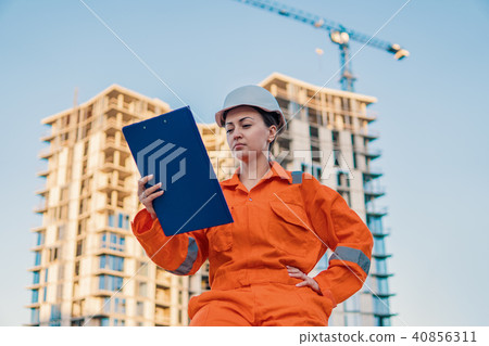 beatiful business woman engineer wearing orange coverall beatiful business woman engineer wearing orange coverall 40856311