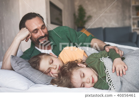 Outgoing father embracing tired kids Outgoing father embracing tired kids 40856461