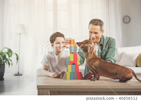 Cheerful family playing together in apartment 40856512