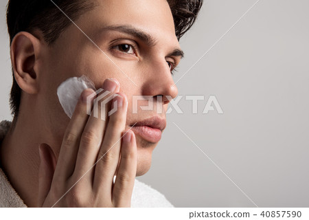 Young man is caring about his appearance Young man is caring about his appearance 40857590