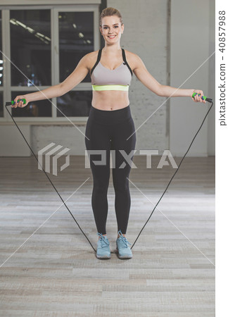 Joyful female doing jumping exercises Joyful female doing jumping exercises 40857988