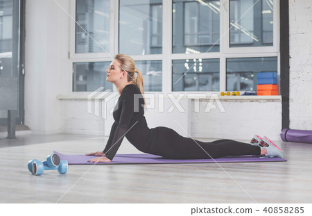 Calm attractive girl working out in fitness room 40858285