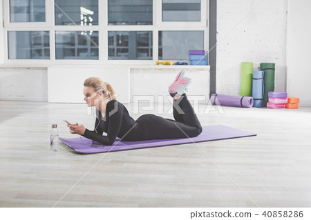 Beautiful girl is having rest during fitness in gym 40858286