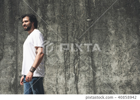 Smiling guy being fond of walking around deserted areas 40858942