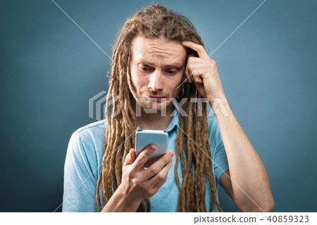 Young man staring at his cellphone 40859323