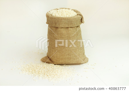White rice in burlap sack bag on white background. White rice in burlap sack bag on white background. 40863777