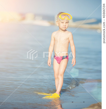 Cute little kid wearing mask and flippers for diving at sand tropical beach. Cute little kid wearing mask and flippers for diving at sand tropical beach. 40866594