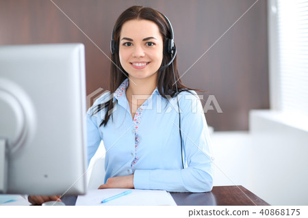 Young brunette business woman looks like a student girl working in office. Hispanic or latin Young brunette business woman looks like a student girl working in office. Hispanic or latin 40868175