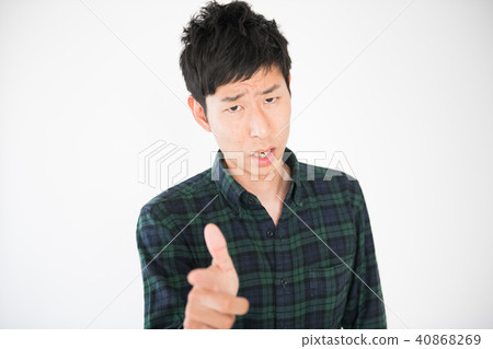 A young Japanese male pointing out 40868269