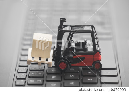 Forklift miniature with wooden block on keyboard Forklift miniature with wooden block on keyboard 40870003