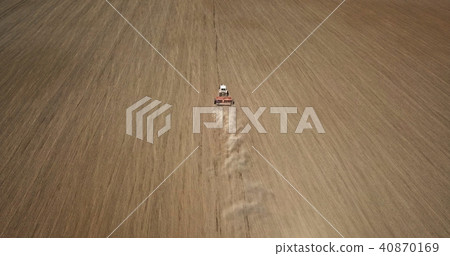 Aerial view the work of the tractor in the field in the spring. Photo from the drone 40870169
