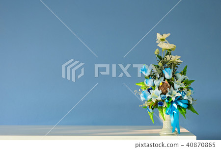Bouquet artificial flowers vase with blue wall 40870865