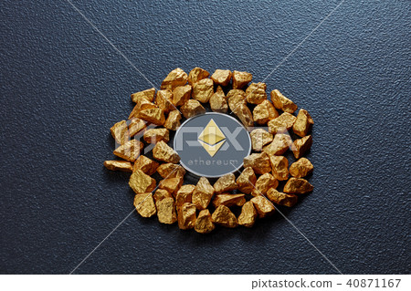 Etereum coin and golden nuggets on a black concrete background. Business, finance and technology Etereum coin and golden nuggets on a black concrete background. Business, finance and technology 40871167
