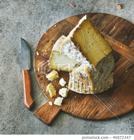 Cheese assortment on board, close-up, vertical composition 40872347