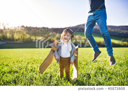 Happy toddler boy playing outside with father in spring nature. 40872608