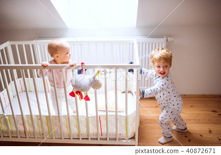 Two toddler children in bedroom at home. Two toddler children in bedroom at home. 40872671