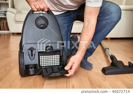 Replacing a hepa filter in vacuum cleaner at home. 40872714