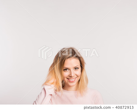 Portrait of a young beautiful woman in studio on a white background. Portrait of a young beautiful woman in studio on a white background. 40872913