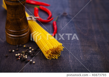 Spaghetti on a dark wooden background. Spaghetti on a dark wooden background. 40873793